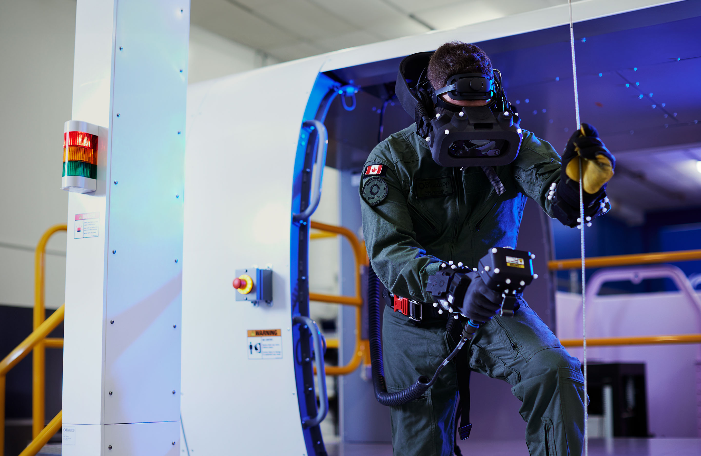 Header Image. Man wearing VR headset holding a device and cable